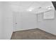 Unfinished basement space ready for customization with carpet flooring and window at 2344 Hollyridge Sw Dr, Marietta, GA 30060