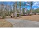 View of a single story brick house with a long driveway and a wooded lot at 2344 Hollyridge Sw Dr, Marietta, GA 30060