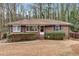 Charming brick home with manicured bushes and black shutters on a sunny day at 2344 Hollyridge Sw Dr, Marietta, GA 30060