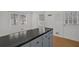 Kitchen island with dark granite counter and wood floors near back door at 2344 Hollyridge Sw Dr, Marietta, GA 30060