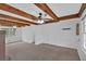 Open living area featuring beamed ceiling, neutral carpet, and lots of natural light at 2344 Hollyridge Sw Dr, Marietta, GA 30060