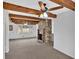 Open living room with a stone fireplace and exposed wood beams at 2344 Hollyridge Sw Dr, Marietta, GA 30060