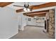 Open living room with a stone fireplace and exposed wood beams at 2344 Hollyridge Sw Dr, Marietta, GA 30060