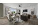 Comfortable living room showcasing modern decor, a ceiling fan, and large windows for natural light at 371 Foxglove Way, Mcdonough, GA 30253