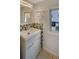 Bathroom featuring vanity with modern hardware, mirror and mosaic tile accent wall with window at 835 Glendale Ne Ter # 6, Atlanta, GA 30308