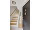 View of the tiled foyer showing entry and staircase with wood treads and white risers at 835 Glendale Ne Ter # 6, Atlanta, GA 30308