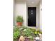 A stylish black front door with the number 6, framed by lush greenery and charming yellow flowers at 835 Glendale Ne Ter # 6, Atlanta, GA 30308