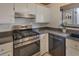 Close up of a Kitchen with white cabinets, granite countertops, and stainless steel appliances at 835 Glendale Ne Ter # 6, Atlanta, GA 30308