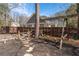 Fenced backyard with a mulch bed, stone pathway, and a classic wooden swing set at 1309 Arnold Ne Ave, Atlanta, GA 30324