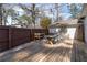 Outdoor wooden deck with dining table and chairs overlooking the fenced yard at 1309 Arnold Ne Ave, Atlanta, GA 30324