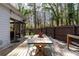 Outdoor wooden deck with dining table and chairs, perfect for enjoying meals outside at 1309 Arnold Ne Ave, Atlanta, GA 30324