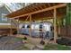 Airstream trailer parked under a wooden shelter in the backyard, surrounded by greenery at 1309 Arnold Ne Ave, Atlanta, GA 30324