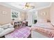 Cozy bedroom with stylish rug, single bed, desk, and view to the bathroom at 1309 Arnold Ne Ave, Atlanta, GA 30324
