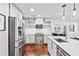 Updated kitchen with stainless steel appliances, white cabinets, and a breakfast bar at 1309 Arnold Ne Ave, Atlanta, GA 30324