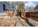 Side yard with a wood fence, raised garden beds, and gravel ground cover at 1309 Arnold Ne Ave, Atlanta, GA 30324