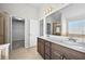 Bathroom with double vanity, large mirror, and tiled flooring at 1566 Wilson Manor Cir, Lawrenceville, GA 30045