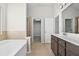 Bathroom with double sinks, a bathtub, and a separate shower stall at 1566 Wilson Manor Cir, Lawrenceville, GA 30045