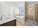 Bathroom featuring double sinks, bathtub, and glass shower stall at 1566 Wilson Manor Cir, Lawrenceville, GA 30045