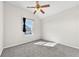 Bedroom featuring a window, neutral carpet, and a ceiling fan at 1566 Wilson Manor Cir, Lawrenceville, GA 30045