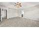Spacious bedroom with a tray ceiling, ceiling fan, and neutral carpeting at 1566 Wilson Manor Cir, Lawrenceville, GA 30045