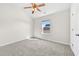 Bright bedroom featuring neutral walls, carpet floors, and a ceiling fan for optimal comfort at 1566 Wilson Manor Cir, Lawrenceville, GA 30045