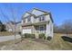 Attractive home showcasing a well-maintained lawn, neutral siding, and a cozy front porch at 1566 Wilson Manor Cir, Lawrenceville, GA 30045