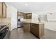 Gourmet kitchen with an island, stainless steel refrigerator, granite countertops, and stainless steel appliances at 1566 Wilson Manor Cir, Lawrenceville, GA 30045