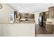 Open-concept kitchen with granite countertops, stainless steel appliances, and a breakfast bar area at 1566 Wilson Manor Cir, Lawrenceville, GA 30045