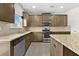 Modern kitchen showcasing granite countertops, stainless steel appliances, and ample cabinet space at 1566 Wilson Manor Cir, Lawrenceville, GA 30045