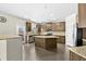 Spacious kitchen features a large island, stainless steel appliances, granite countertops, and modern cabinets at 1566 Wilson Manor Cir, Lawrenceville, GA 30045