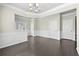 Elegant living area boasting hardwood floors, decorative wainscoting, and a stylish chandelier at 1566 Wilson Manor Cir, Lawrenceville, GA 30045