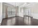 Spacious living room with dark hardwood floors, crown molding, and ample natural light at 1566 Wilson Manor Cir, Lawrenceville, GA 30045