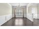 Bright living space featuring hardwood floors, wainscoting detail, and modern lighting fixtures at 1566 Wilson Manor Cir, Lawrenceville, GA 30045
