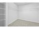 Walk-in closet with wire shelving and neutral carpeting at 1566 Wilson Manor Cir, Lawrenceville, GA 30045