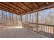 Outdoor covered porch overlooking a wooded backyard at 172 White Rose Ln, Temple, GA 30179