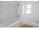 Clean bathroom with a large tub and shower, and white tiling at 172 White Rose Ln, Temple, GA 30179