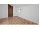 Cozy bedroom featuring wood-look floors and a rustic barn door at 172 White Rose Ln, Temple, GA 30179