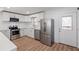Modern kitchen featuring stainless steel appliances, white cabinets, and hardwood floors at 172 White Rose Ln, Temple, GA 30179