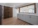 Open concept kitchen with white cabinets, modern countertops, and rustic beam accents at 172 White Rose Ln, Temple, GA 30179