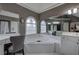 Well-appointed bathroom featuring a soaking tub and vanity area with natural light and lots of mirrors at 3534 Brandywine Nw Rd, Kennesaw, GA 30144