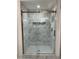 This bathroom has a gold-framed glass shower door with white marble-style tile and a shower niche at 3534 Brandywine Nw Rd, Kennesaw, GA 30144