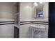 Bathroom featuring a pedestal sink, mirror, and white subway tile with black trim at 3534 Brandywine Nw Rd, Kennesaw, GA 30144