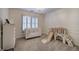 Bright bedroom featuring neutral tones, shuttered windows, crown molding, and play equipment at 3534 Brandywine Nw Rd, Kennesaw, GA 30144