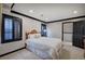 Cozy bedroom features neutral walls with black trim, a queen bed, and a private bathroom at 3534 Brandywine Nw Rd, Kennesaw, GA 30144