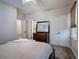 Neutral bedroom with a large bed, dresser, double closets, and an attached bathroom at 3534 Brandywine Nw Rd, Kennesaw, GA 30144
