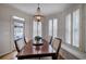 Bright dining room featuring a beaded chandelier and built-in window bench seating at 3534 Brandywine Nw Rd, Kennesaw, GA 30144