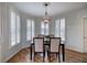 Bright dining room featuring hardwood floors, plantation shutters, and a chandelier at 3534 Brandywine Nw Rd, Kennesaw, GA 30144