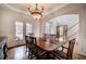 Elegant dining room featuring a chandelier, hardwood floors, and access to the main foyer, creating a seamless flow at 3534 Brandywine Nw Rd, Kennesaw, GA 30144