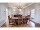 Formal dining room with elegant chandelier, striped chairs, and French doors, perfect for gatherings and entertaining at 3534 Brandywine Nw Rd, Kennesaw, GA 30144