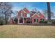 Inviting two-story brick home with manicured lawn and covered front porch at 3534 Brandywine Nw Rd, Kennesaw, GA 30144